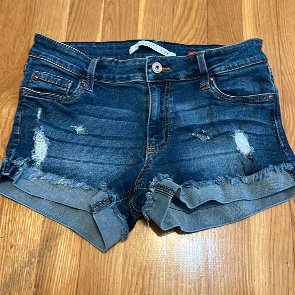 Slightly ripped jean shorts with fringe on bottom